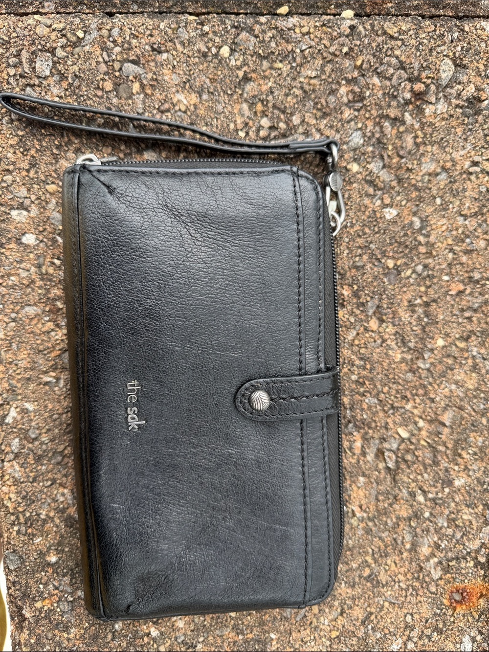 The Sak Black Leather Wristlet Wallet with Snap Tab